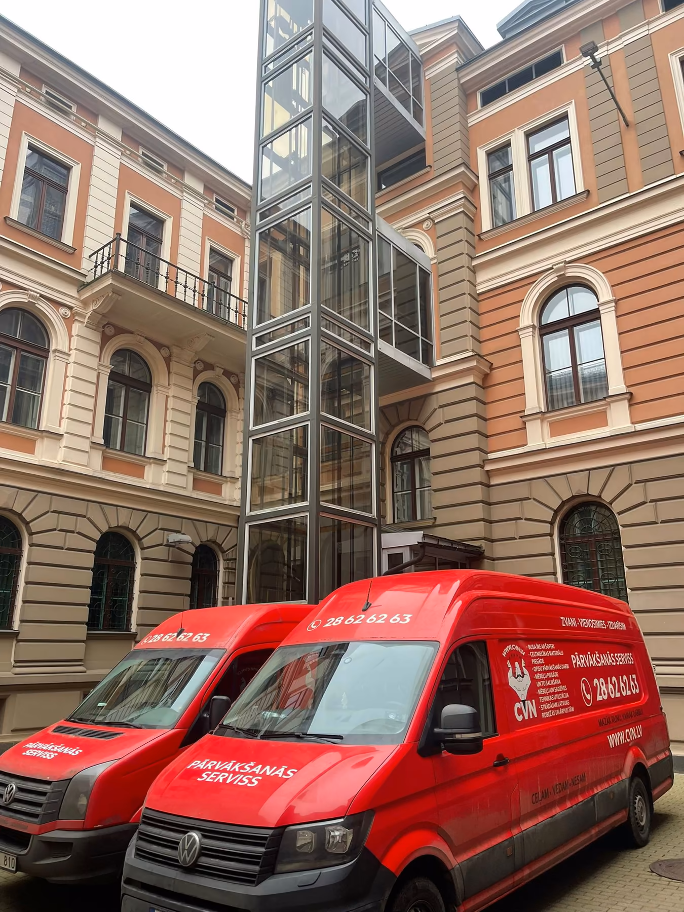 CVN vans in a historic courtyard