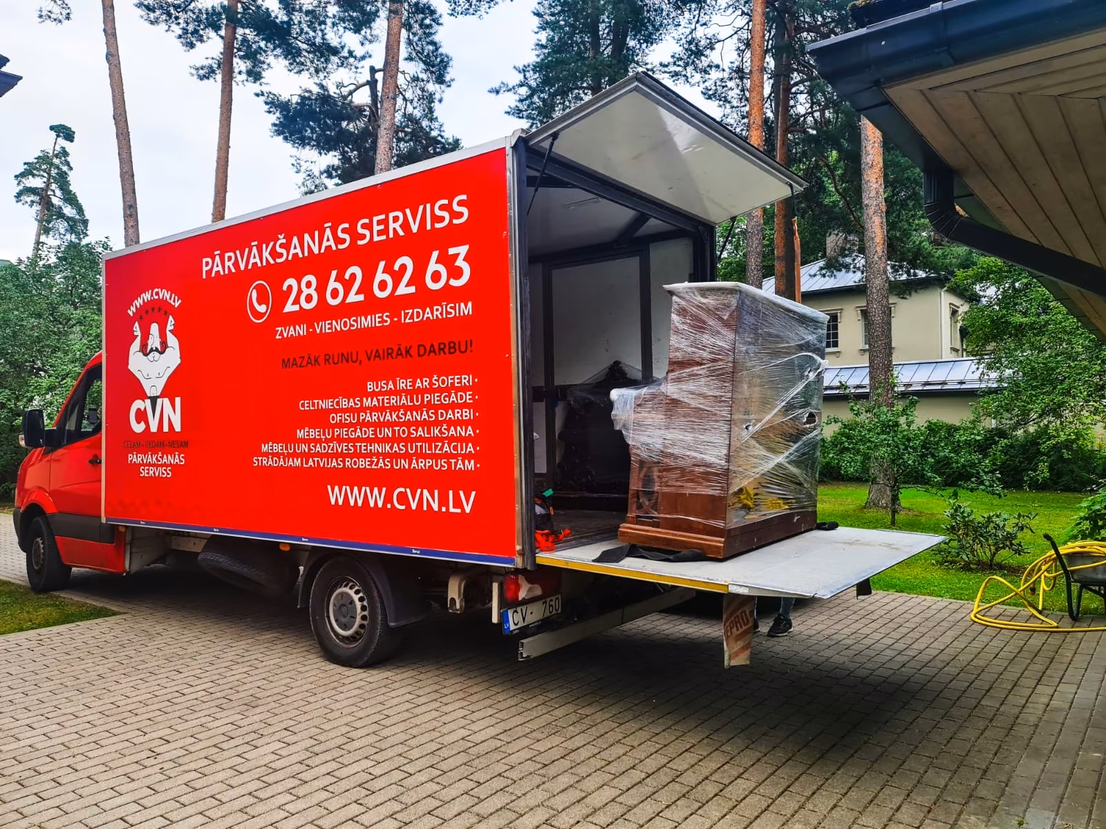 Truck with tail lift and wrapped furniture