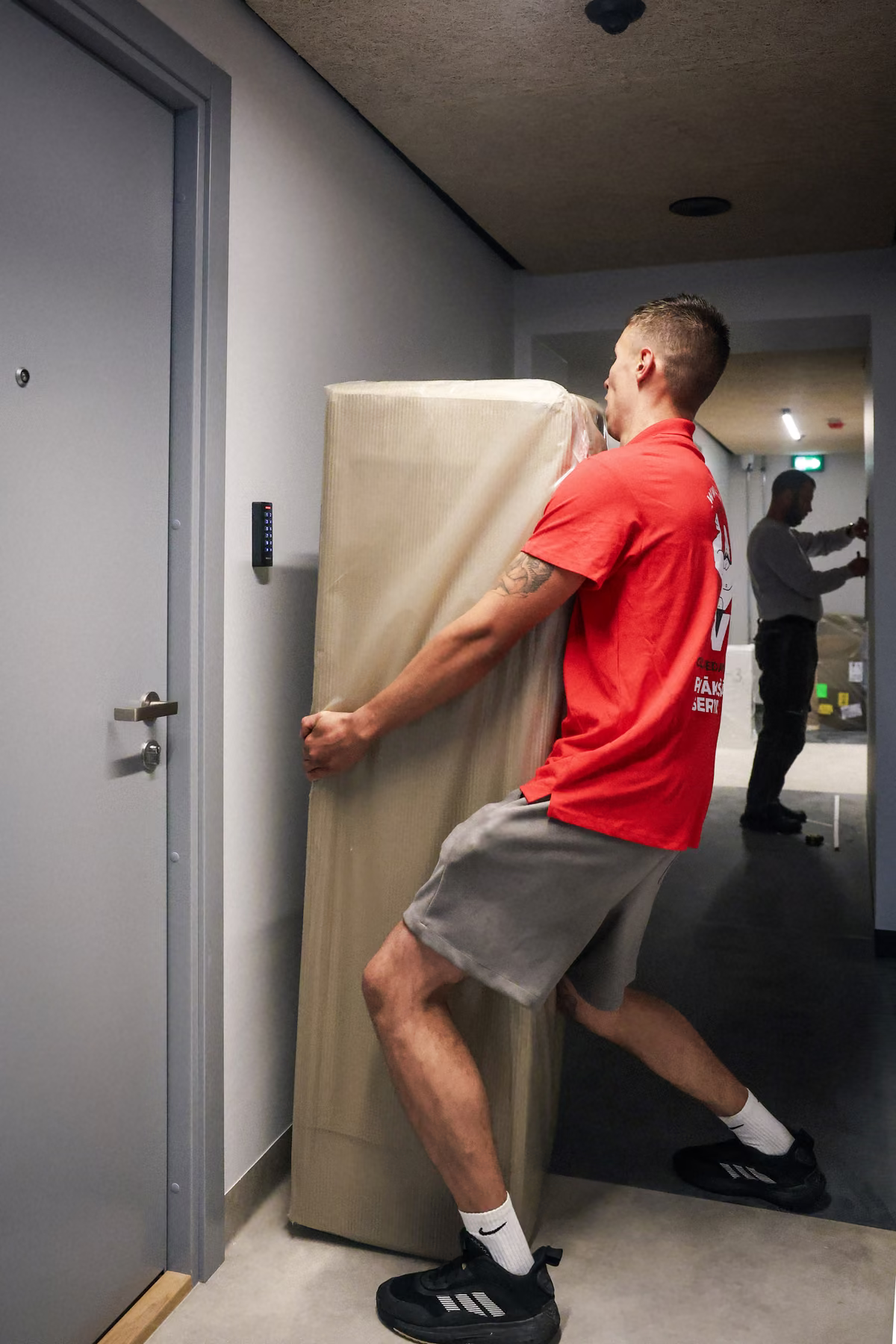 Carrying furniture in protective wrapping